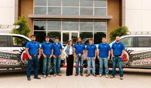 The R2 Mechanical HVAC team standing with their service trucks outside the shop in Krum, Texas